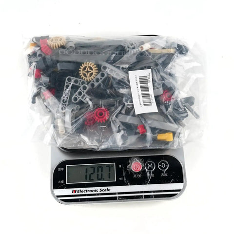 Level Up Your Build Game With Rock Solid 5 Plus 1 Speed With Reverse Transmission Gearbox Building Blocks Kit in plastic bag on scale.