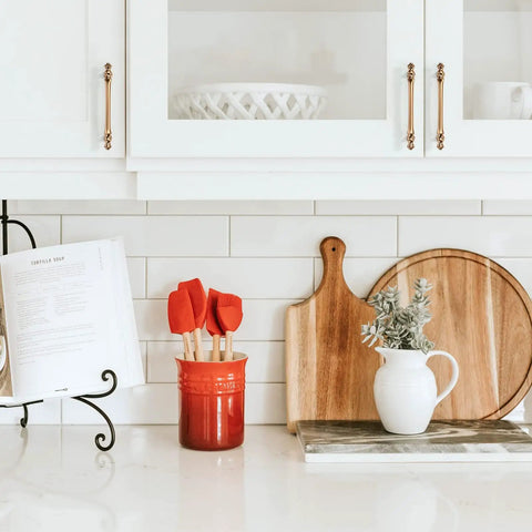 Kitchen with Six Pack 5 Inch Champagne Bronze Cabinet Handles 128mm Brushed Brass on white cupboards, visible installation.