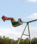 Child swinging on Big Brutus Galvanized Steel Swing Set Kit with Classic A Frame Two Belt Swings Trapeze Bar Easy Assembly.