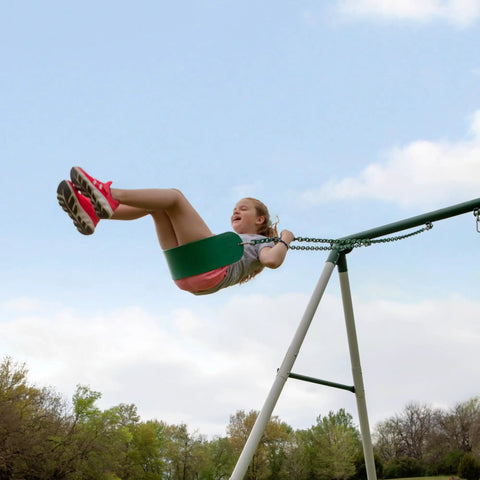 Child swinging on Big Brutus Galvanized Steel Swing Set Kit with Classic A Frame Two Belt Swings Trapeze Bar Easy Assembly.