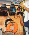 Tradesman Pro Modular Drill Pouch with Belt Clip attached to wall rack, storing various tools in durable 1680D ballistic weave pouches.