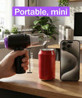 Hand holding 3 In 1 Computer Cleaning Tool With 110000 RPM Electric Air Duster And 14500 Pa Vacuum USB Rechargeable Handheld Dust Cleaner near a soda can and smartphone