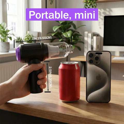Hand holding 3 In 1 Computer Cleaning Tool With 110000 RPM Electric Air Duster And 14500 Pa Vacuum USB Rechargeable Handheld Dust Cleaner near a soda can and smartphone
