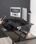 Electric Height Adjustable Desk Converter With Sit To Stand Function And Dual Monitor Riser 42 Inch Workstation Stand Up Desk With USB Port Black Finish No Fuss Electric Lift For Home Office in use with two monitors and keyboard