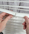 Easy DIY Slick Fix For Cracked Horizontal Blinds Clear Mini Slat Repair Kit With String Holes and Solid Tabs being applied to blind slats.