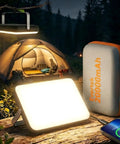 Beast 20,000mAh Portable LED Work Light and Camping Lantern in use at night in front of a tent, showing rotatable stand and power bank feature.