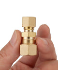 Brass compression union fitting 3/8 in x 1/4 in tube OD held in hand