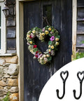 Dope Black Cast Iron Heart Shaped Wall Hooks For Home Decor Vibes And Closet Organization Heavy Duty Decorative Craft Hanging Hardware Reliable Set Of Two Pieces with floral wreath