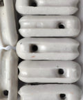 Close-up of a 22 pack of glazed ceramic antenna insulators for dipole, inverted Vee, end-fed and long-wire antennas.