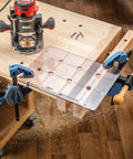 Spaced Dog Hole Router Template for Precise Holes and Bench Tools like Dogs Cookies and Holdfasts on woodworking bench.