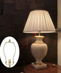Straight Fire Slick Polished Brass Lamp Harp 10 Inch Light Duty Replacement Hardware attached to a table lamp with fabric shade.