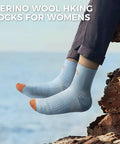 Feet wearing Women Merino Wool Hiking Socks Pack Of 5 Quarter Crew Length Thermal Warmth Cushioned Comfort near a rock edge.