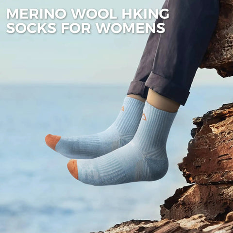 Feet wearing Women Merino Wool Hiking Socks Pack Of 5 Quarter Crew Length Thermal Warmth Cushioned Comfort near a rock edge.
