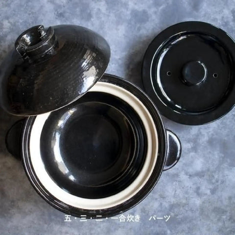 Top view of Hase En Kamado San Earthenware Rice Pot For Gas Stoves With Double Lid, showing interior and open lids.