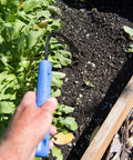 Hand using Classic Weeder And Cultivator Garden Go To Hand Tool With Forged Steel Blade And Recycled Plastic Handle for planting