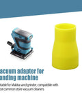 Yellow vacuum adapter for sanding machine, compatible with common store vacuums, shown next to a blue sander.