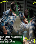 Two children wearing Dinosaur Roaring Headlamps For Kids With LED Light Fun Camping Flashlight exploring indoors at night