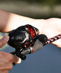 Person holding Brutus Spincast Fishing Reel With Reversible Left Or Right Handle Dual Stainless Steel Pickup System for freshwater use.