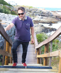 Man walking down stairs with Non Slip Outdoor Stair Treads 4x24 Inch Diamond Textured Rubber Mats for Steps visible.