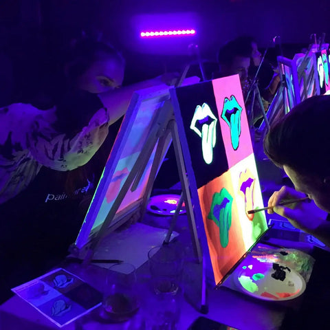 People painting under Three Pack 36W Black Light Bars With 5Ft US Plug And On Off Switch For Glow Party Stage Lighting