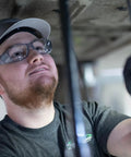 Worker wearing Emerge Plus Readers Safety Glasses With Rubber Nosepiece And Temple Tips Clear 1.5 Diopter Magnification