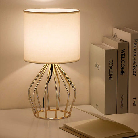 Gold Table Lamp For Desk And Nightstand Modern Style Desk Light With Hollow Base And Linen Fabric Shade in a room setting