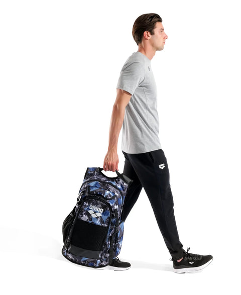 Person carrying All Set Multisport Swim Backpack for Gym and Training 45L Large Capacity Rucksack with blue pattern.