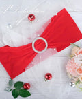 Red Spandex Chair Sash from the 30-pack with buckle slider for wedding decoration, shown on decorative backdrop with flowers and ornaments.