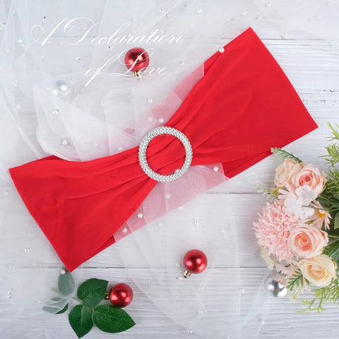 Red Spandex Chair Sash from the 30-pack with buckle slider for wedding decoration, shown on decorative backdrop with flowers and ornaments.