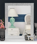 Easy Peel And Stick Glitter Wallpaper used as a frame on a mirror, showing a reflection of a bedside with a lamp and decor.