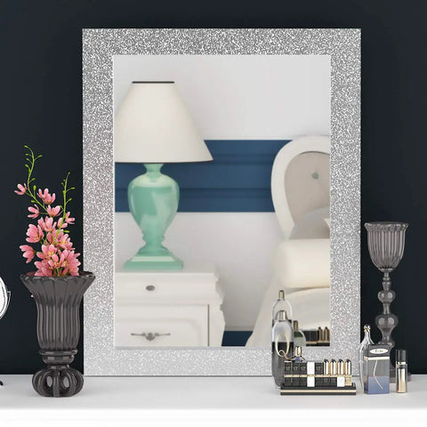 Easy Peel And Stick Glitter Wallpaper used as a frame on a mirror, showing a reflection of a bedside with a lamp and decor.
