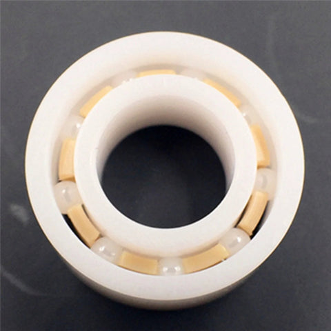 R188 full ceramic ball bearing, 1/4 x 1/2 x 3/16 in, top view with white ceramic balls in outer race