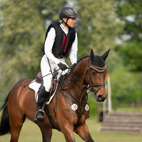 Equestrian rider on horse using Bow Balance Stirrup Pads in Stainless Steel for Pro Riders, 12cm Long, durable upgrade in motion