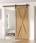 Installed view of Six Point Six Feet Long Sliding Barn Door Hardware Kit For Single Door Sturdy Durable Carbon Steel With Black Coating To Prevent Rust Heavy Duty Easy To Install Fits Thirty Six To Forty Inch Wide Doors J Shape Hanger Included with wooden door in a bright room.