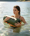 Person using Do It All 3 In 1 Inflatable Water Weight Bag for camping, swim float and tent anchor, portable storage, 10L green.