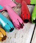 Close-up of colorful metal garden trowels set of 10 hand shovels for kids teens and adults in pink, red, blue, orange, and green.