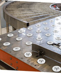 12 Pack Mounted Ball Bearing Transfer Casters installed on industrial metal surface for smooth, easy mobility of heavy materials.