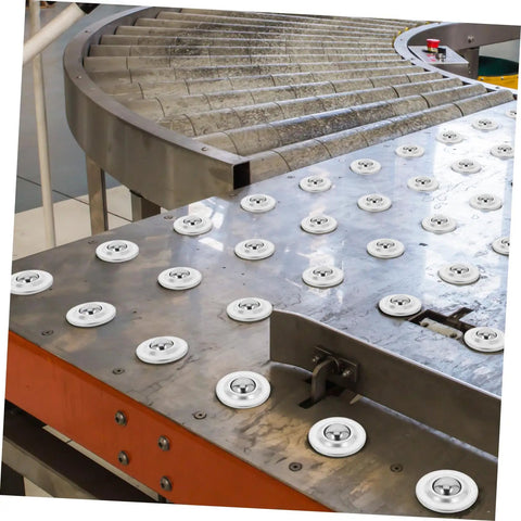 12 Pack Mounted Ball Bearing Transfer Casters installed on industrial metal surface for smooth, easy mobility of heavy materials.