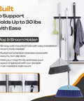 Heavy Duty Stainless Steel Broom Holder Wall Mount With 3 Racks And 4 Hooks holding brooms, mops, and cleaning tools in use.