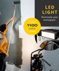 Man painting wall with Heavy Duty 300 Lb Hand Truck That Converts To A 5 In 1 Mobile Workshop With Built In 3 Speed Fan And LED Light nearby