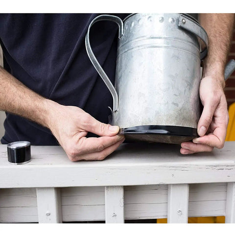 Person applying 1 Inch Self Fusing Silicone Hose Repair Tape 10 Ft Black 0.5mm Thick Heavy Duty Leak Proof Rubber Tape to a metal jug.