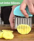 Aphohome 2-pack stainless steel crinkle cutters with green and sky-blue handles, slicing a potato into ridged pieces.