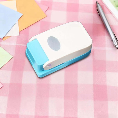 Dope Tiny Paper Punch Hole Puncher For Scrapbooking And Photo Albums on pink checkered surface with colorful paper sheets