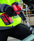Worker using Cordless Hammer Drill Driver SF 6H A22 Bulk For Brick Masonry And Concrete Jobs with Lightweight Build on construction site