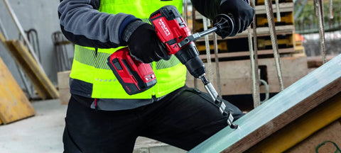 Worker using Cordless Hammer Drill Driver SF 6H A22 Bulk For Brick Masonry And Concrete Jobs with Lightweight Build on construction site