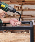 DIY Ready Home Tool Kit With Drill Driver, shown drilling into metal frame, flexible extension in use, in woodworking shop.