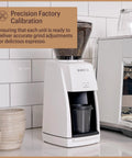 Premium Black Conical Burr Coffee Grinder Crafted For On Point Espresso Pulls Featuring Slick Micro Dial Controls A Top Shelf Build That Always Delivers The Goods For Real Coffee Heads, white design with visible coffee beans.