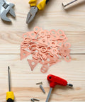 Auto Dent Repair Kit with 50 dent puller rings and washers on wooden surface with tools