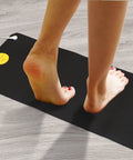 Person standing on Grounding Bed Mat With No Slip Bottom And Tangle Free Cord For Better Sleep Pain Relief Circulation Boost Reduced Inflammation And Calm 26.7x9.8 In 2 Pack For Home Office Meditation, showing feet in close-up