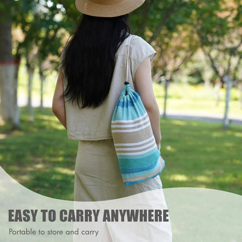 Person carrying Easy Setup 1 To 2 Person Outdoor Hammock With Tree Straps And Carry Bag, Portable Canvas Hammock in blue and green.